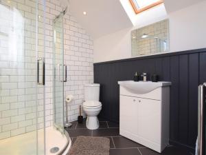 a bathroom with a toilet and a sink and a shower at 3 Bed in North Tawton oc-66043 in Winkleigh
