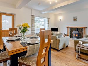 a living room with a table and a couch at 3 Bed in Brecon oc-96240 in Llandefaelogfâch