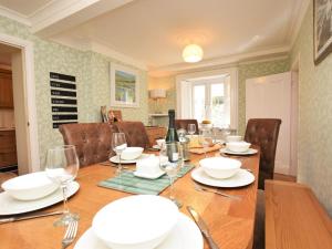 a dining room with a wooden table and chairs at 4 Bed in Barnstaple oc-73949 in Stoke Rivers