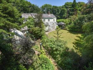 an aerial view of a large white house on a hill at 4 Bed in Barnstaple oc-73949 in Stoke Rivers
