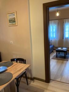 a living room with a table and a dining room at Historic House in the Heart of Old Town Sozopol in Sozopol