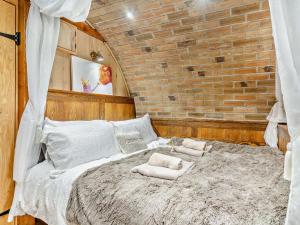 a bedroom with a large bed with two pillows on it at 1 Bed in Brecon oc-95630 in Aber-Brân