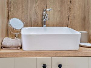 a bathroom sink with a faucet and a mirror at 1 Bed in Brecon oc-95630 in Aber-Brân +18 photos