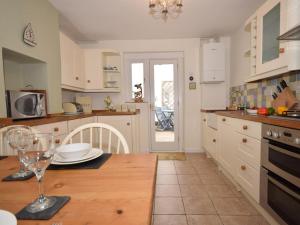a kitchen with a table with a wine glass on it at 2 Bed in Bideford oc-tcdolph in Appledore