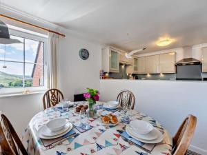 a dining room with a table and chairs and a kitchen at 2 Bed in Woolacombe oc-bkers in Woolacombe +12 photos