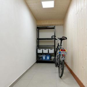 a bike parked in a room with a shelf at Apartament Blue Green Velo in Bartoszyce