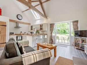 a living room with a couch and a table at 1 Bed in Craven Arms oc-54928 in Clungunford