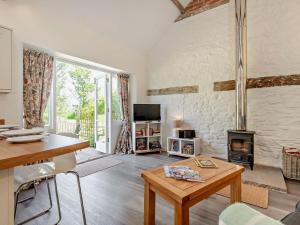 a living room with a table and a fireplace at 1 Bed in Craven Arms oc-54928 in Clungunford