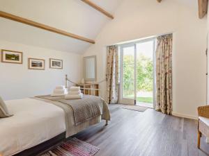 a bedroom with a bed and a large window at 1 Bed in Craven Arms oc-54928 in Clungunford