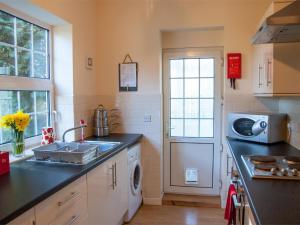 a kitchen with a sink and a microwave at 2 Bed in Neath oc-bn247 in Crynant +10 photos