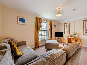a living room with a couch and a tv at 2 Bed in Bideford oc-40281 in Northam