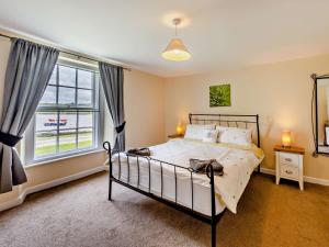 a bedroom with a bed and a large window at 2 Bed in Bideford oc-40281 in Northam
