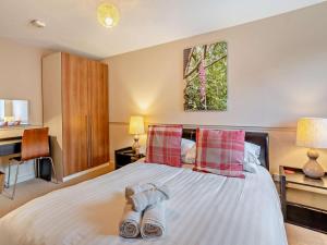 a bedroom with a bed with two shoes on it at 3 Bed in Brecon oc-bn304 in Brecon