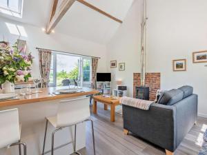 a living room with a couch and a table at 1 Bed in Craven Arms oc-54926 in Clungunford