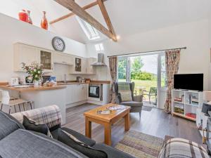 a living room with a couch and a table at 1 Bed in Craven Arms oc-54926 in Clungunford