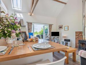 a dining room with a wooden table and a fireplace at 1 Bed in Craven Arms oc-54926 in Clungunford +11 photos