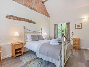 a bedroom with a large bed and a window at 1 Bed in Craven Arms oc-54926 in Clungunford