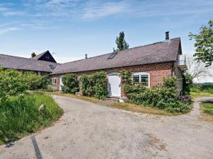a brick house with a white door and a driveway at 1 Bed in Craven Arms oc-54926 in Clungunford