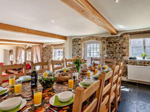 a dining room with a long table and chairs at 6 Bed in Bideford oc-thorn in Buckland Brewer