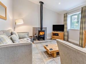 a living room with a couch and a fireplace at 2 Bed in Pontypool oc-58962 in Mamhilad