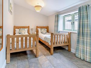 a bedroom with two beds and a window at 2 Bed in Pontypool oc-58962 in Mamhilad