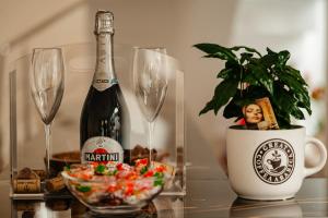 a bottle of champagne and a potted plant on a table at Atri's Boutique in Aiud