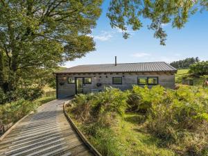 a stone house with a wooden walkway leading to it at 1 Bed in Llandrindod Wells oc-53194 in Llandrindod Wells