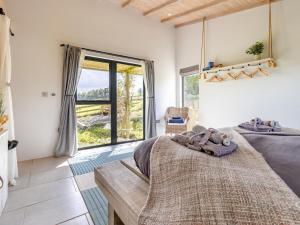 a bedroom with a large bed and a large window at 1 Bed in Llandrindod Wells oc-53194 in Llandrindod Wells