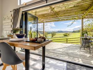 a dining room with a table and a view of a field at 1 Bed in Llandrindod Wells oc-53194 in Llandrindod Wells