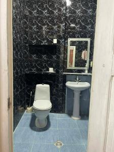 a bathroom with a toilet and a sink at Nana's Guest House in Sighnaghi +68 photos