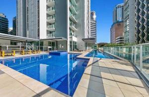 a swimming pool in a building with tall buildings at CITY Centre With Awesome Views! in Brisbane