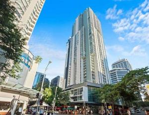 a tall glass building in a city with buildings at CITY Centre With Awesome Views! in Brisbane