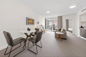 a living room with a table and chairs at CITY Centre With Awesome Views! in Brisbane +9 photos