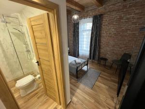 a bathroom with a shower and a toilet in a room at Tejmalom Szálló in Sárrétudvari