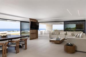 a living room with a couch and a table at Oliva D'oro Villa - Sunset Gaze by etouri in Chania
