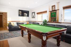 a living room with a pool table in it at Infinity Views in Utakarra