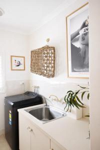 a kitchen with a sink and a black refrigerator at Infinity Views in Utakarra +13 photos