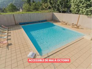 a large swimming pool with two chairs at L'Igloo - Balcon- Vue- Chic pres St-Lary in Vignec +11 photos