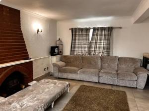 a living room with a couch and a fireplace at 5 Bedroom house Doncaster in Balby