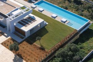 an aerial view of a house with a swimming pool at Oliva D'oro Villa - Sunset Gaze by etouri in Chania +63 photos