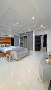 a large bedroom with a bed and a couch at 3Apartments in Lagos