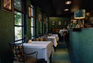 a row of tables in a restaurant with white table cloth at Hotel Van Cleef in Bruges +70 photos