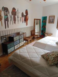 a bedroom with a bed and a dresser and a chair at Casa Laura in Modigliana