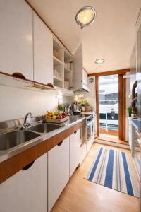 a kitchen with white cabinets and a view of the ocean at Sea Panther in Il-Gżira
