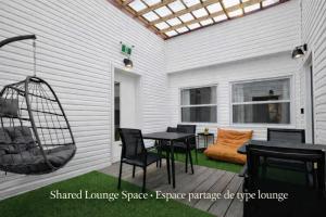 a patio with a swing and a table and chairs at Room with a King-Size Bed Downtown Quebec in Quebec City