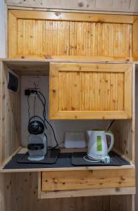 a wooden cupboard with a coffee maker and a blender at B&B dalla Nonna in Salerno