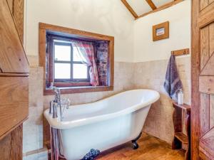 a bath tub in a bathroom with a window at 1 Bed in Usk- oc-79936 in Llandenny +21 photos
