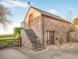 an old brick house with a wooden door and stairs at 1 Bed in Usk- oc-79936 in Llandenny