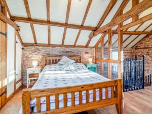 a bedroom with a wooden bed in a room at 1 Bed in Usk- oc-79936 in Llandenny