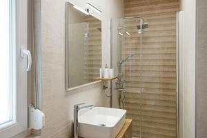 a bathroom with a sink and a shower at Apartment Karmen in Šilo +18 photos